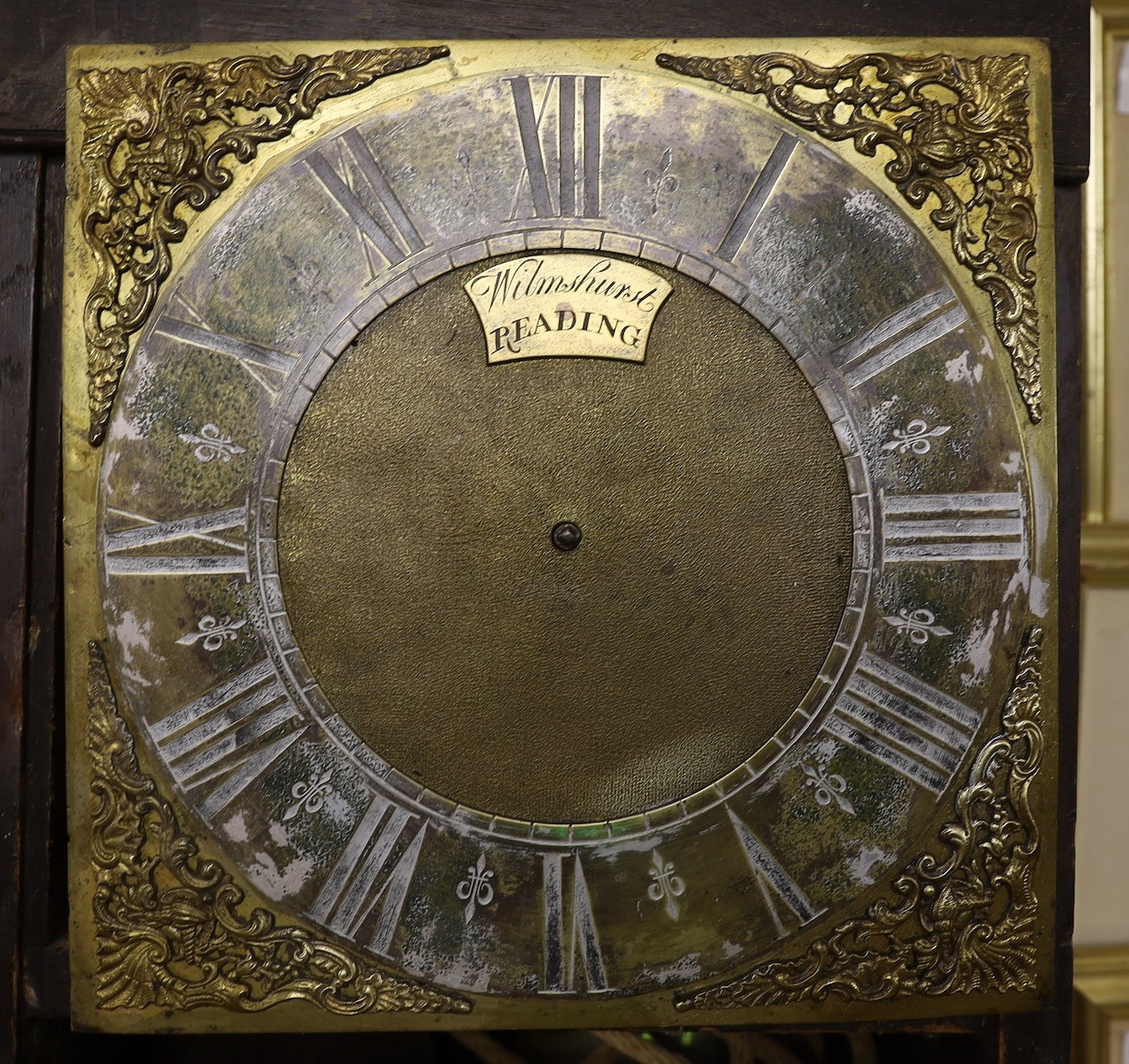 A thirty hour oak hooded wall clock, signed Wilmhurst, Reading
